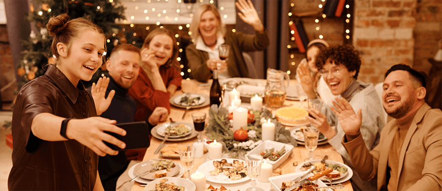 Family gathering around the table for a selfie over the holiday season