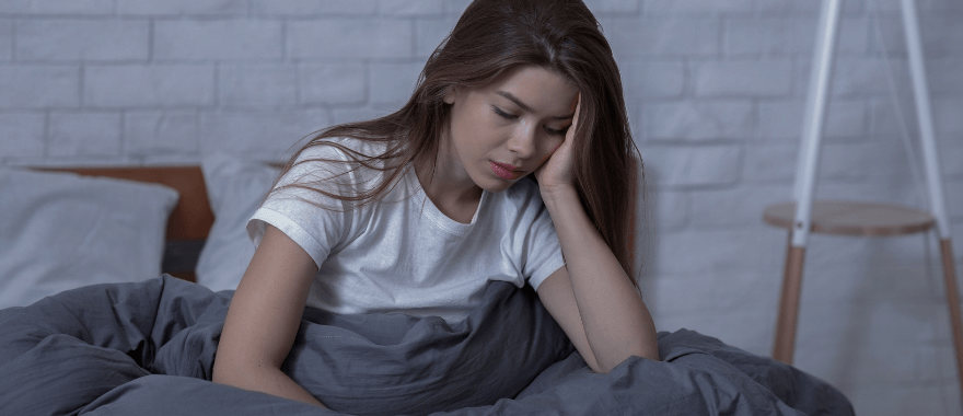Image of a tired female in bed affected by SAD
