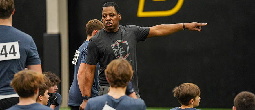 Terrance Bryant coaching athletes at Sanford Academy 7 on 7 football tryouts