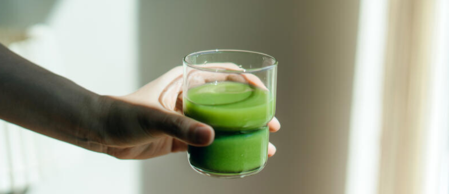 Person holding a green juice