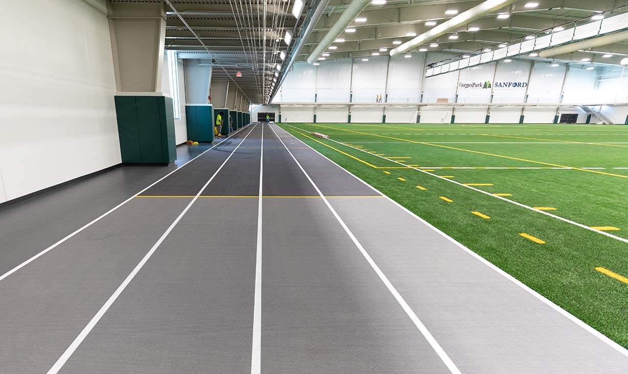 View of the indoor turf field with a running track 