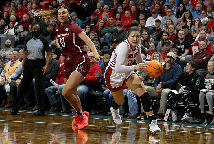South Dakota's Jeniah Ugofsky drives past South Carolina's Kamilla Cardoso during their game at the Sanford Pentagon