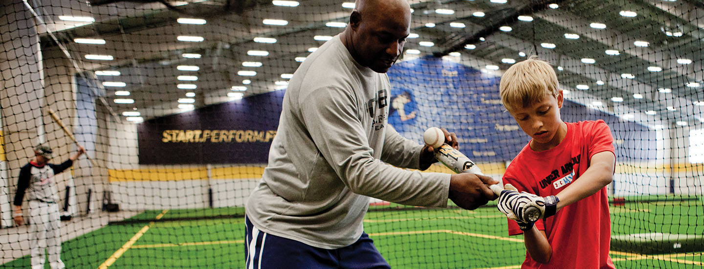 Steve Phillips training a youth baseball player