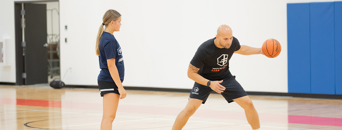 basketball dills with young girl and coach