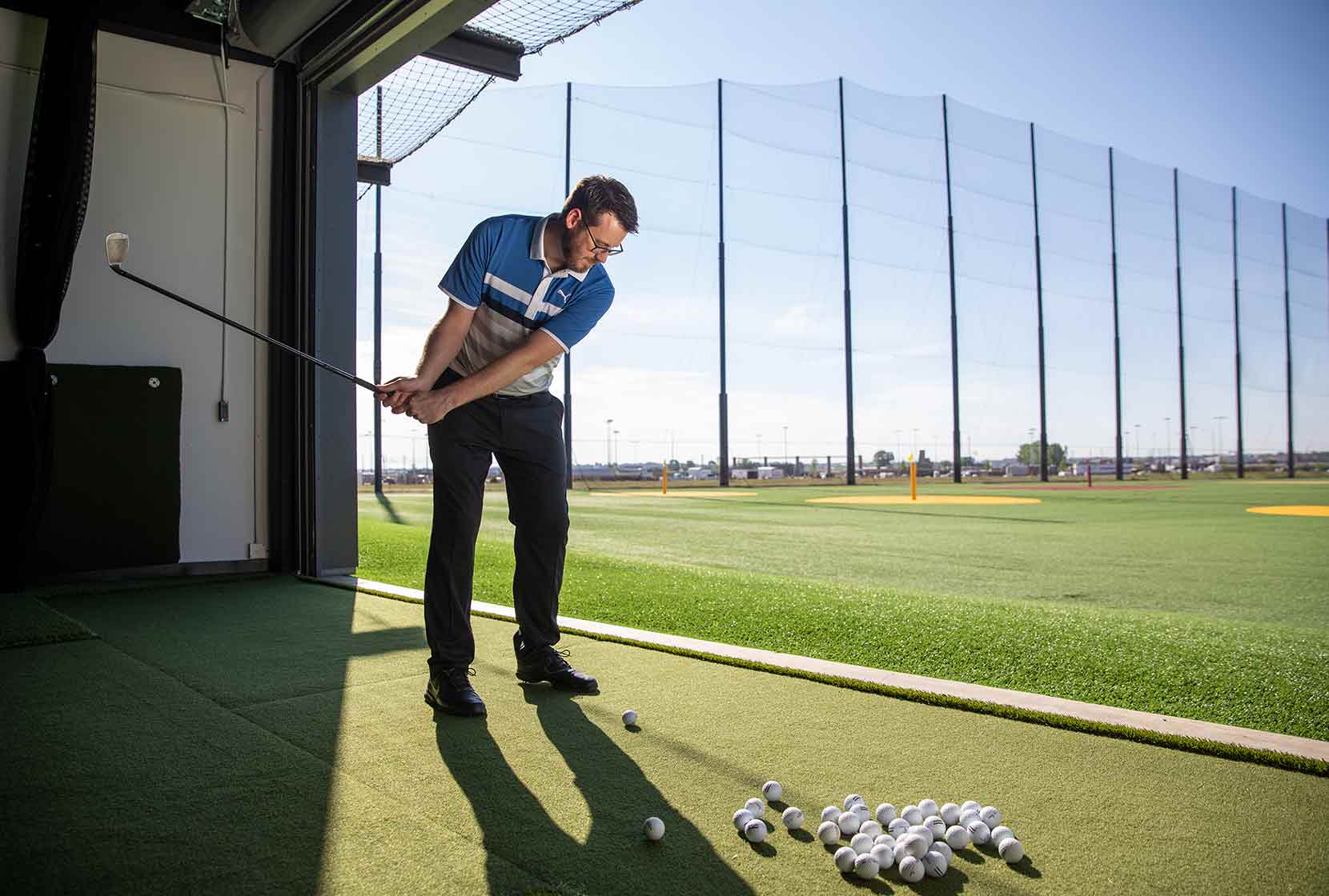 person hitting golf balls at Great Shots