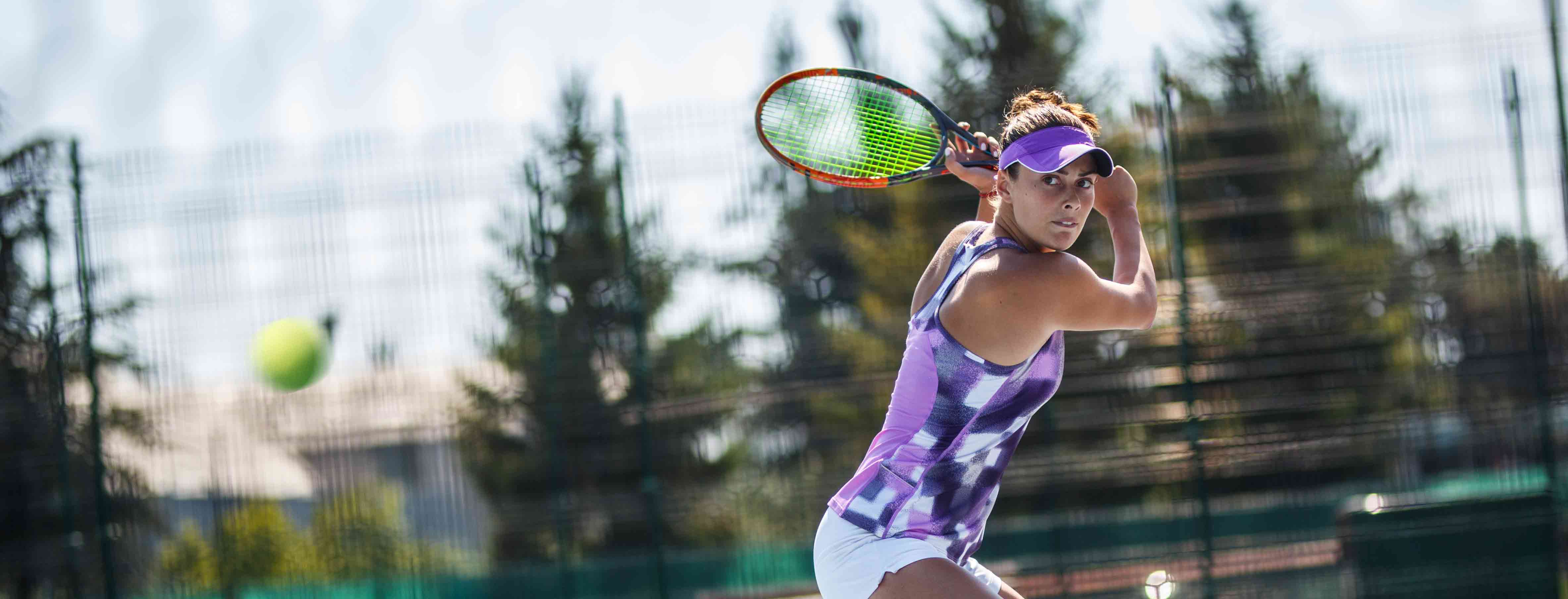 athlete hitting tennis ball from a distance